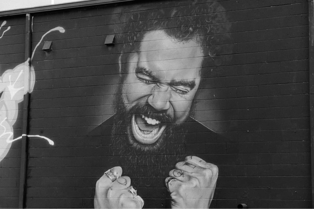 A wall mural of a man singing 
