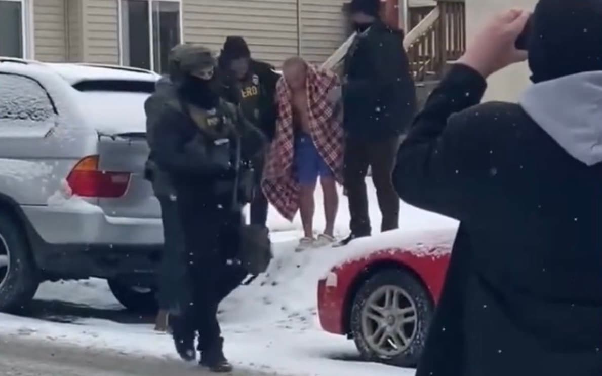 Behind the disturbing image of ICE snatching a half-naked, elderly Hmong American from his home - Featured Image