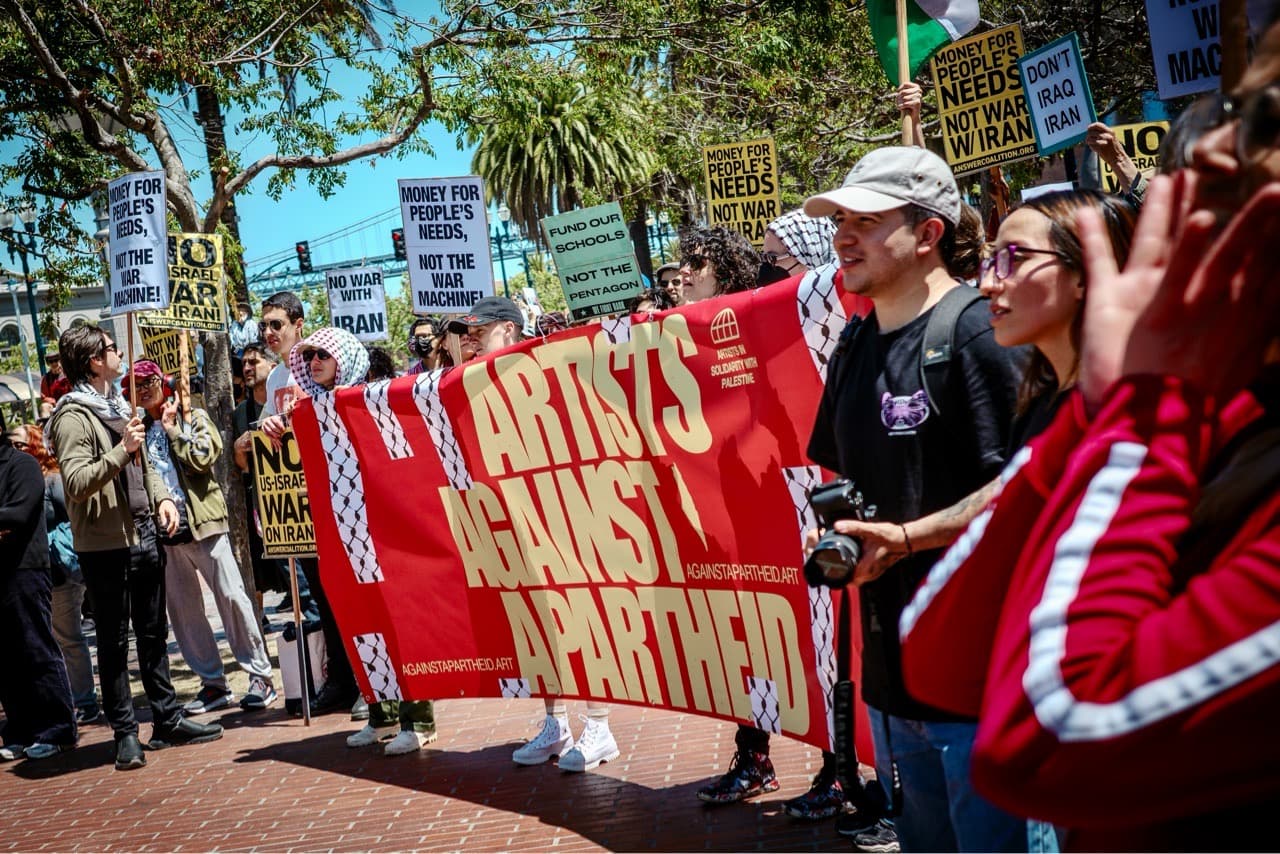 Protestors holding a large banner that says "Artists against apartheid"