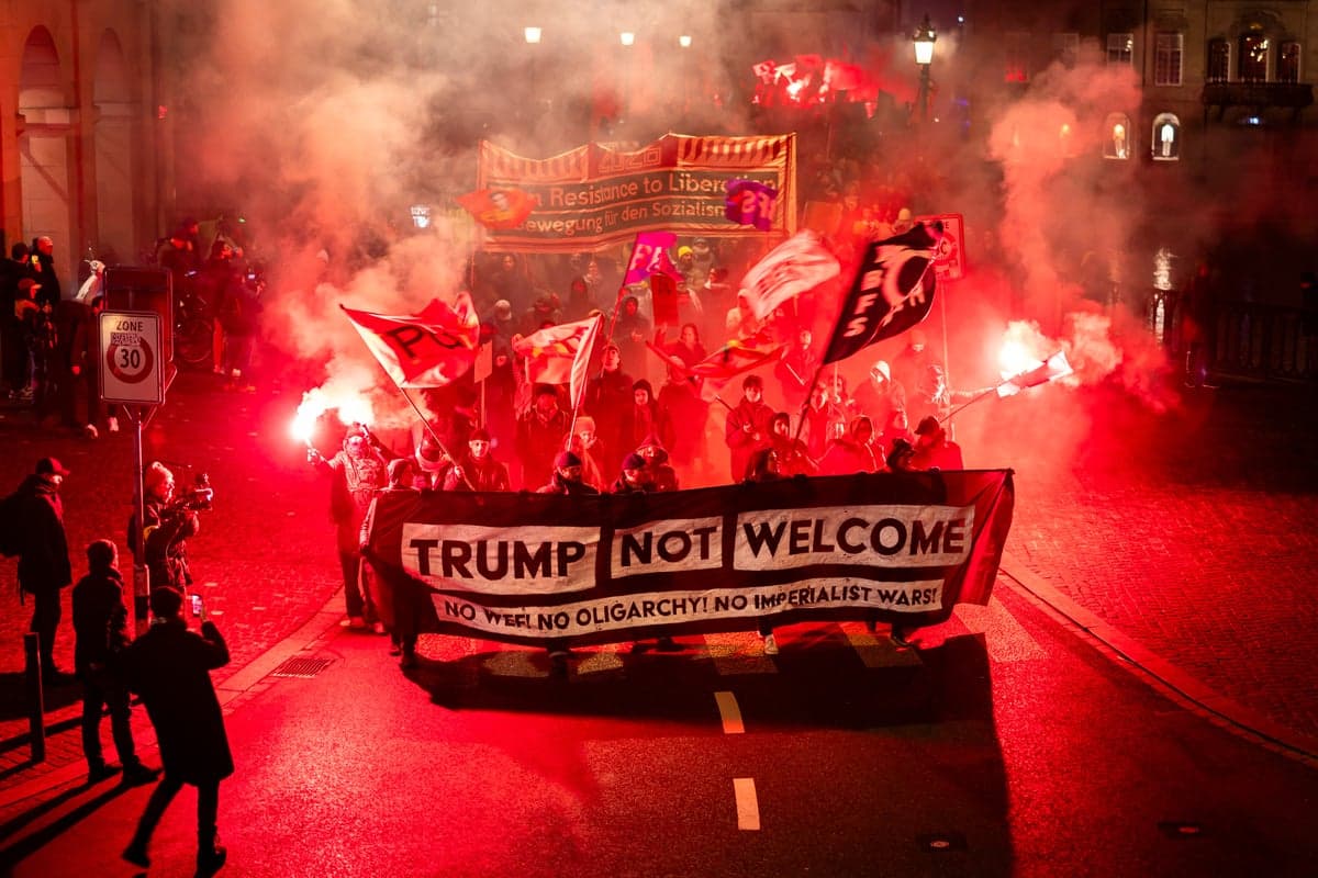 Anti Trump protesters burn American flags in Switzerland ahead of president’s Davos trip | The Independent - Featured Image