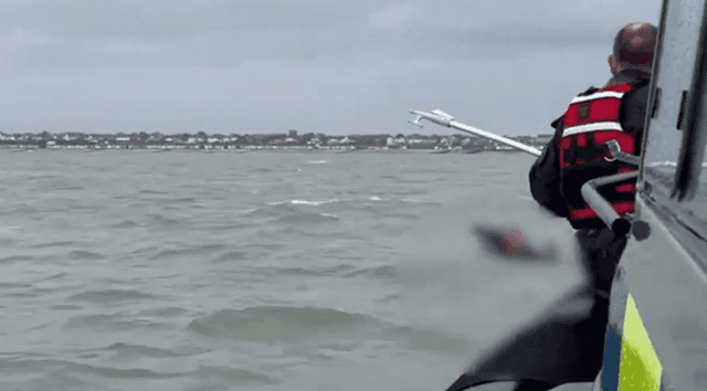 Moment two men ‘minutes from drowning’ are spotted in desperate rescue attempt after being swept out to sea - Featured Image