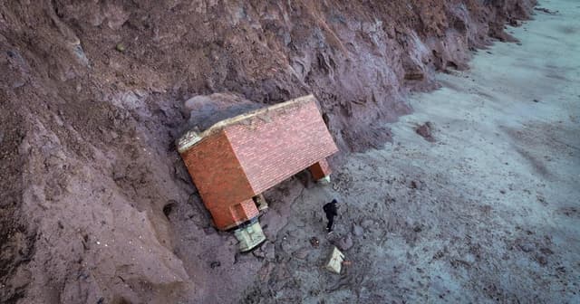 Nuclear bunker crashes into beach below in Tunstall after succumbing to coastal erosion | News UK | Metro News - Featured Image